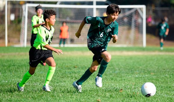 Two Region 13 boys compete for the ball on a Saturday game